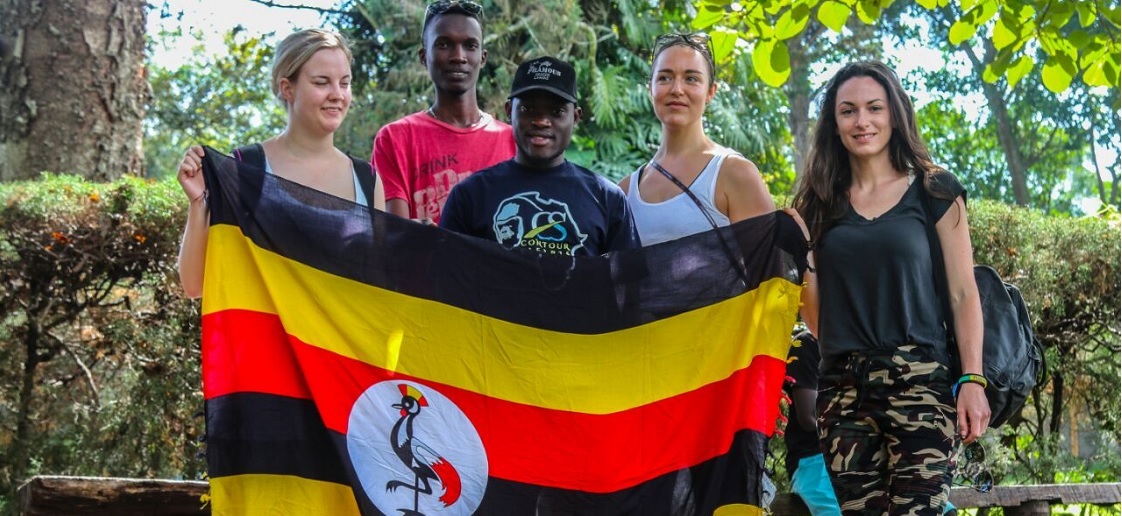 contour safaris holding uganda flag
